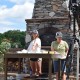 shooting a cooking video in front of an outdoor brick oven